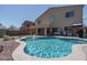 Backyard pool with fountain and covered patio, perfect for outdoor entertaining and relaxation at 11832 W Electra Ln, Sun City, AZ 85373