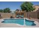 Stunning backyard features a pool, a pergola with seating, and lush landscaping at 11832 W Electra Ln, Sun City, AZ 85373