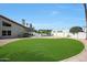 Lush green backyard, surrounded by desert landscaping and privacy fence, offers a serene retreat for outdoor enjoyment at 12222 N 74Th St, Scottsdale, AZ 85260