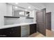 Entertaining bar with storage cabinets, counter seating, and a wine fridge at 12222 N 74Th St, Scottsdale, AZ 85260