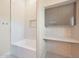 Clean bathroom features white tub with shower and built in vanity at 12222 N 74Th St, Scottsdale, AZ 85260