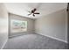 Neutral bedroom featuring a large window and ceiling fan at 12222 N 74Th St, Scottsdale, AZ 85260
