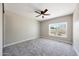 Light-filled bedroom offering neutral walls, a ceiling fan, and a large window at 12222 N 74Th St, Scottsdale, AZ 85260
