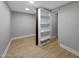 Small walk-in closet featuring wood-look flooring and custom shelving at 12222 N 74Th St, Scottsdale, AZ 85260