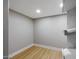 Small walk-in closet featuring wood-look flooring and custom shelving at 12222 N 74Th St, Scottsdale, AZ 85260