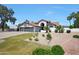 Stunning home featuring a manicured front yard and a three-car garage, perfect for any homeowner at 12222 N 74Th St, Scottsdale, AZ 85260