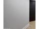 Hallway with textured walls, wood-look flooring, and a dark accent door at 12222 N 74Th St, Scottsdale, AZ 85260