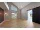 Open living space with high ceilings, a modern light fixture, and access to a walk-in closet and bathroom at 12222 N 74Th St, Scottsdale, AZ 85260