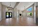 Spacious living room with a fireplace, high ceilings, modern light fixtures, and a view of the pool at 12222 N 74Th St, Scottsdale, AZ 85260