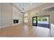 Bright living room with a stone fireplace and floor-to-ceiling sliding glass doors leading to the pool at 12222 N 74Th St, Scottsdale, AZ 85260