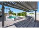 Backyard paradise featuring an outdoor kitchen with a built-in grill and a covered pergola overlooking the pool at 12222 N 74Th St, Scottsdale, AZ 85260
