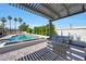 Stylish outdoor kitchen area with modern BBQ and pergola, ideal for entertaining poolside in a private backyard at 12222 N 74Th St, Scottsdale, AZ 85260