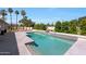 Beautiful backyard pool with stone accents and mature landscaping, offering a private and tranquil retreat at 12222 N 74Th St, Scottsdale, AZ 85260
