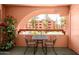 Cozy balcony area with table and chairs overlooking landscaped common area at 12222 N Paradise Village S Pkwy # 220, Phoenix, AZ 85032