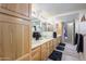 Bright bathroom featuring a double vanity, wood cabinets and granite countertops at 12222 N Paradise Village S Pkwy # 220, Phoenix, AZ 85032