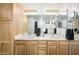 Bright bathroom featuring a double vanity, wood cabinets and granite countertops at 12222 N Paradise Village S Pkwy # 220, Phoenix, AZ 85032