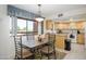 Bright dining area with a large window offering views and an adjacent kitchen space at 12222 N Paradise Village S Pkwy # 220, Phoenix, AZ 85032