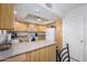 Well-lit kitchen with light wood cabinetry, neutral countertops, and essential appliances included at 12222 N Paradise Village S Pkwy # 220, Phoenix, AZ 85032