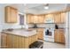 Functional kitchen with light wood cabinets, white appliances, and ample counter space at 12222 N Paradise Village S Pkwy # 220, Phoenix, AZ 85032