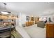 Inviting living room and kitchen area with neutral tones, light-colored cabinets, and access to a private balcony at 12222 N Paradise Village S Pkwy # 220, Phoenix, AZ 85032