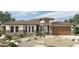 Charming single-story home featuring a stone facade, well-manicured landscaping, and a two-car garage at 12323 W Luxton Ln, Avondale, AZ 85323
