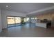 Spacious living room with hardwood floors, large sliding glass doors, and an open layout at 12323 W Luxton Ln, Avondale, AZ 85323