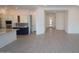 Bright living room showcasing hardwood floors, neutral paint, and open concept with the kitchen at 12323 W Luxton Ln, Avondale, AZ 85323