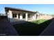 Relaxing backyard featuring a covered patio, artificial turf, and low-maintenance landscaping at 12324 W Parkway Ln, Avondale, AZ 85323