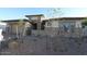 Charming single-story home featuring a stone facade, well-manicured yard, and a two-car garage at 12324 W Parkway Ln, Avondale, AZ 85323
