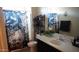 Well-appointed bathroom with vanity and decorative skull themed shower curtain at 1309 W Park St, Phoenix, AZ 85041