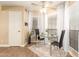 Bright dining area featuring a glass table, chairs, wood floors, white door and large window at 15014 N 48Th Pl, Scottsdale, AZ 85254