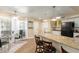 Eat-in kitchen featuring granite countertops, stainless steel appliances, breakfast bar and a dining table at 15014 N 48Th Pl, Scottsdale, AZ 85254