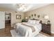 Comfortable bedroom with wood floors, and an adjacent bathroom at 15014 N 48Th Pl, Scottsdale, AZ 85254