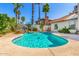 Refreshing pool with a rock feature, lush landscaping and a tiled patio, creating a private oasis at 15014 N 48Th Pl, Scottsdale, AZ 85254
