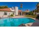 Sparkling blue pool with a tile border, lush landscaping, and patio furniture for outdoor entertaining at 15014 N 48Th Pl, Scottsdale, AZ 85254