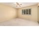 Neutral bedroom featuring a ceiling fan, and white-shuttered windows, and neutral carpet at 160 Leisure World -- # 160, Mesa, AZ 85206