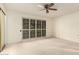 Bedroom with light walls, neutral carpet, ceiling fan, and sliding glass door at 160 Leisure World -- # 160, Mesa, AZ 85206