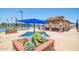 Exterior view of the community center's cabana, landscaping, tennis and pickle ball courts on a sunny day at 160 Leisure World -- # 160, Mesa, AZ 85206