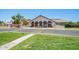 A welcoming community center featuring an inviting entrance, well-kept landscaping, and American flags on display at 160 Leisure World -- # 160, Mesa, AZ 85206