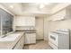 Practical kitchen with tile flooring, white cabinetry, and essential appliances for easy meal preparation at 160 Leisure World -- # 160, Mesa, AZ 85206
