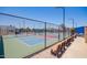 View through a fence of multiple, colorfully surfaced pickle ball courts and shaded seating area at 160 Leisure World -- # 160, Mesa, AZ 85206