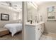 Bright bathroom featuring double sinks, vanity, and a view of the Primary bedroom at 1713 E Bridgeport Pkwy, Gilbert, AZ 85295