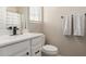 A well-lit bathroom features a white vanity, toilet, and shower with curtains at 1713 E Bridgeport Pkwy, Gilbert, AZ 85295