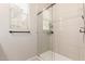 Modern bathroom featuring walk-in shower with glass doors and tiled walls at 1713 E Bridgeport Pkwy, Gilbert, AZ 85295