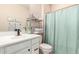 A bathroom with vanity, toilet, and shower with storage space is pictured at 1713 E Bridgeport Pkwy, Gilbert, AZ 85295