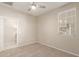 This is a cozy carpeted bedroom with a fan and bright light at 1713 E Bridgeport Pkwy, Gilbert, AZ 85295