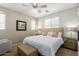 Bright bedroom with a queen bed, wood accent wall, and neutral color scheme at 1713 E Bridgeport Pkwy, Gilbert, AZ 85295