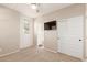 This cozy bedroom features a ceiling fan, TV, and closet for storage at 1713 E Bridgeport Pkwy, Gilbert, AZ 85295