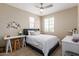 Cozy bedroom with a ceiling fan, complemented by natural light streaming through the windows, desk on left at 1713 E Bridgeport Pkwy, Gilbert, AZ 85295