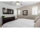Bright bedroom featuring white shiplap accent wall, TV, and a ceiling fan at 1713 E Bridgeport Pkwy, Gilbert, AZ 85295